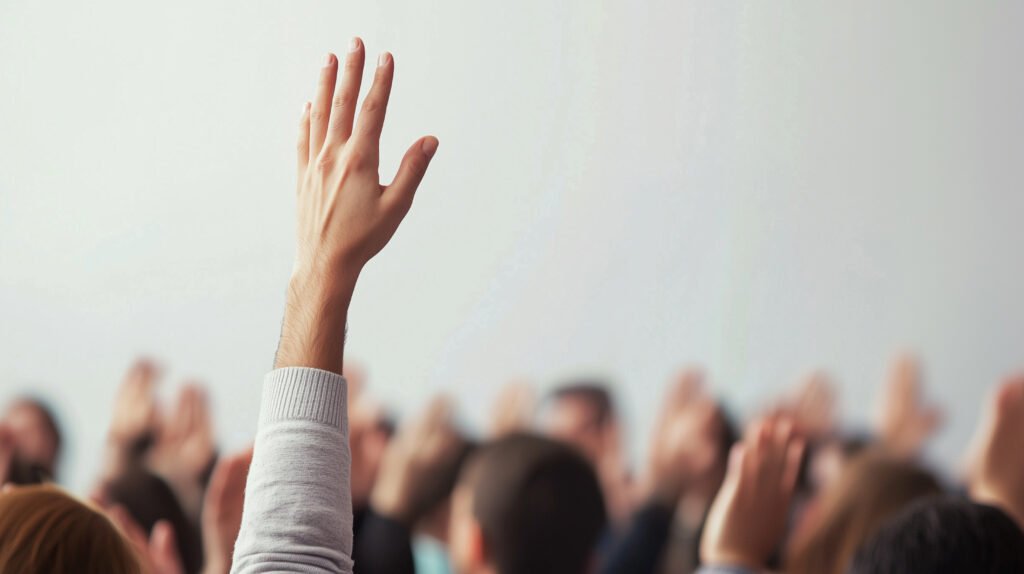 Student raising a hand in a crowded classroom